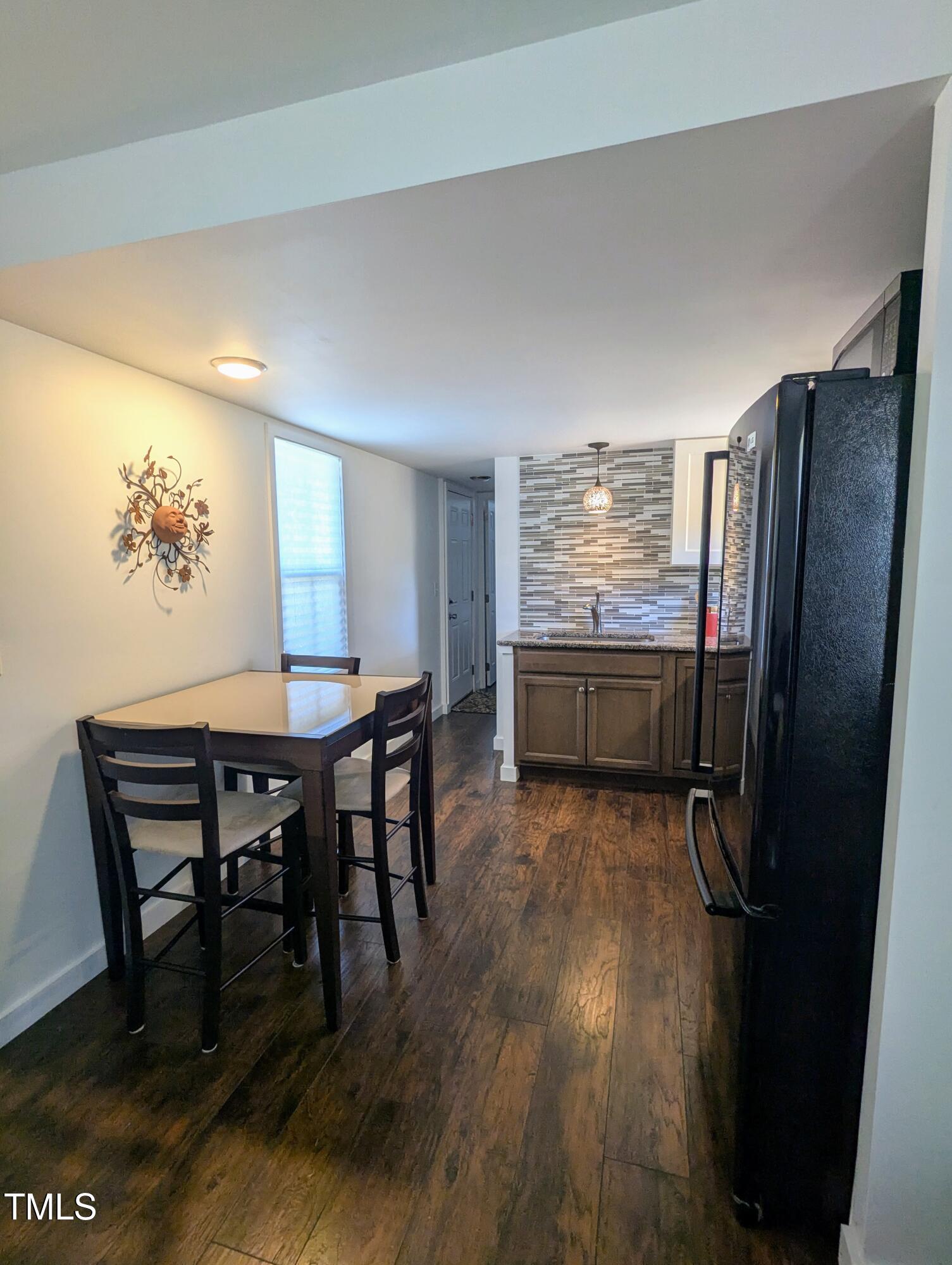 529 Flanagan Road Henderson, NC 27537 - Photo 18 of 38 a view of a dining room with furniture window and wooden floor
