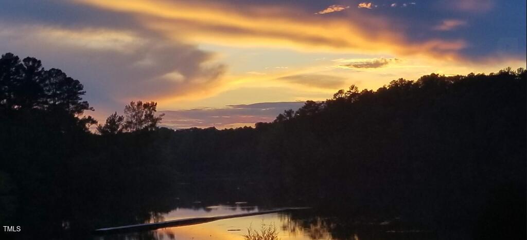 529 Flanagan Road Henderson, NC 27537 - Photo 34 of 38 a view of a lake in middle of sunset