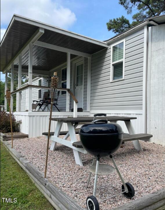 529 Flanagan Road Henderson, NC 27537 - Photo 4 of 38 a view of house with backyard patio and outdoor seating