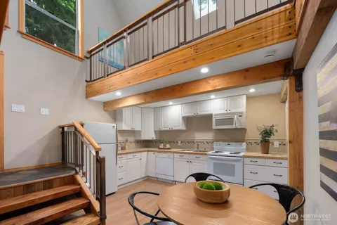 a kitchen with stainless steel appliances kitchen island granite countertop a sink and cabinets