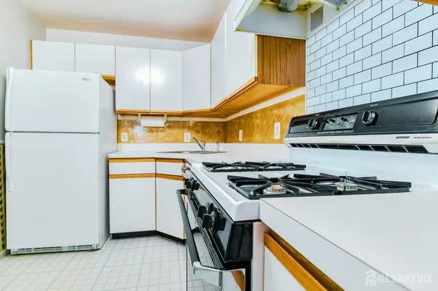 a kitchen with a stove and a refrigerator
