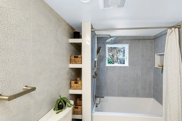 a bath room with a bathtub and a shower