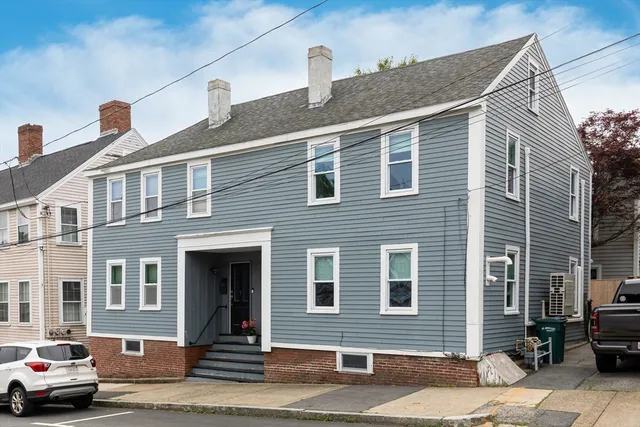 a view of a house with entryway and wooden floor