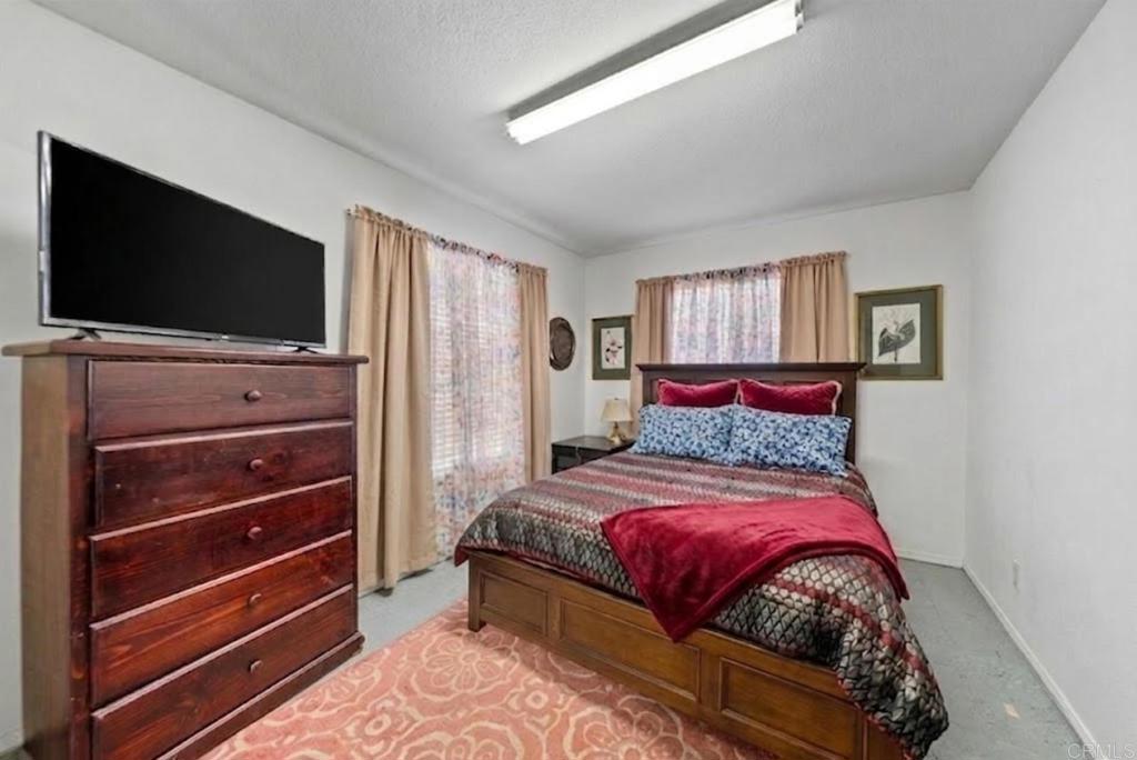 1999 Pecan Tree Street Hemet, CA 92545 - Photo 16 of 38 a bedroom with a bed and a flat screen tv