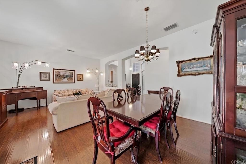1999 Pecan Tree Street Hemet, CA 92545 - Photo 5 of 38 a view of a dining room with furniture and wooden floor