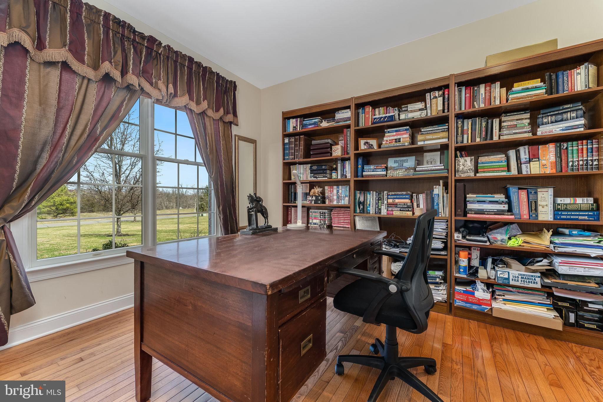 11 Baker Way Pennington, NJ 08534 - Photo 16 of 41 a view of a workspace with furniture and a bookshelf