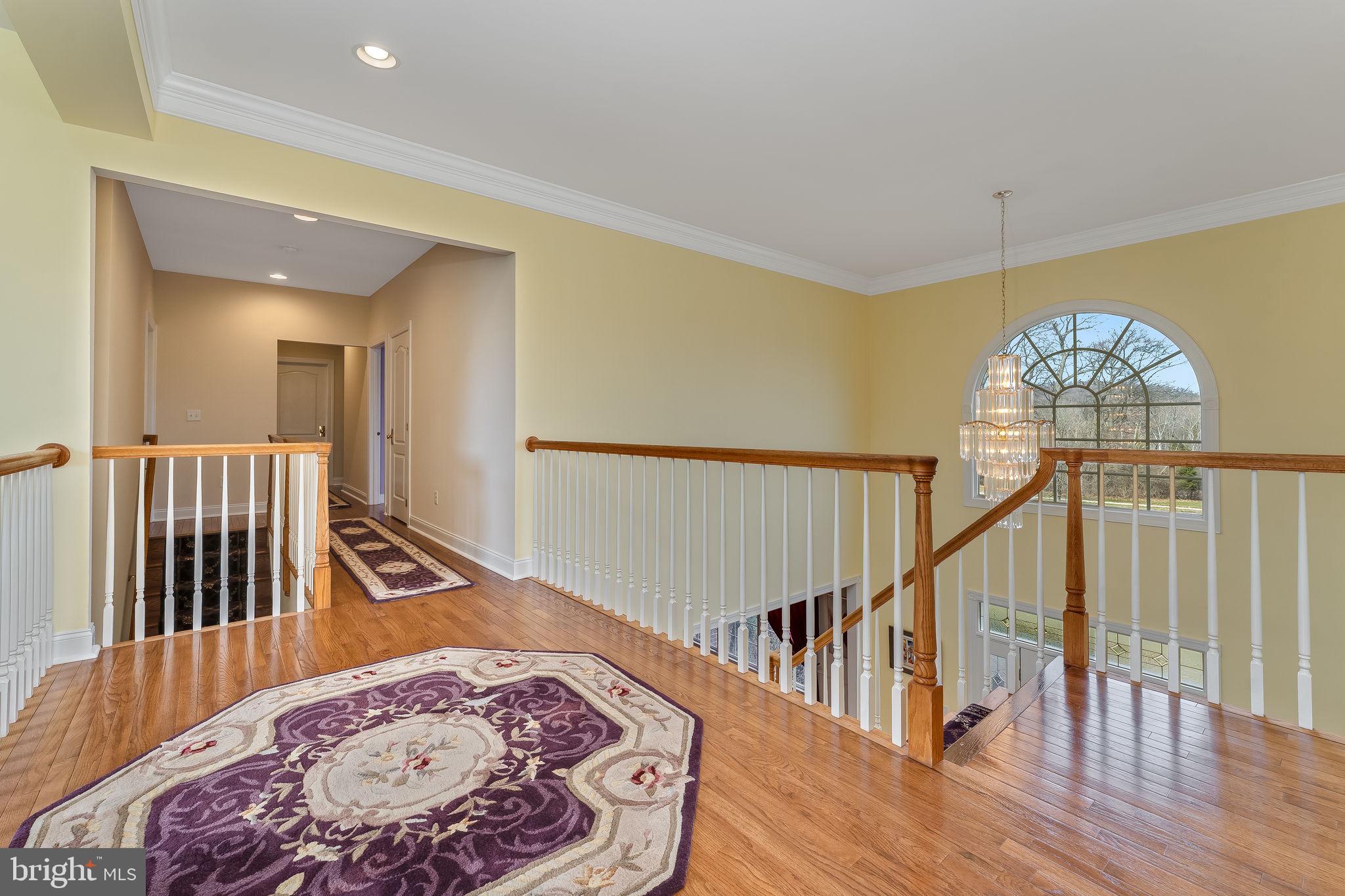 11 Baker Way Pennington, NJ 08534 - Photo 20 of 41 a view of a hallway with wooden floor and stairs
