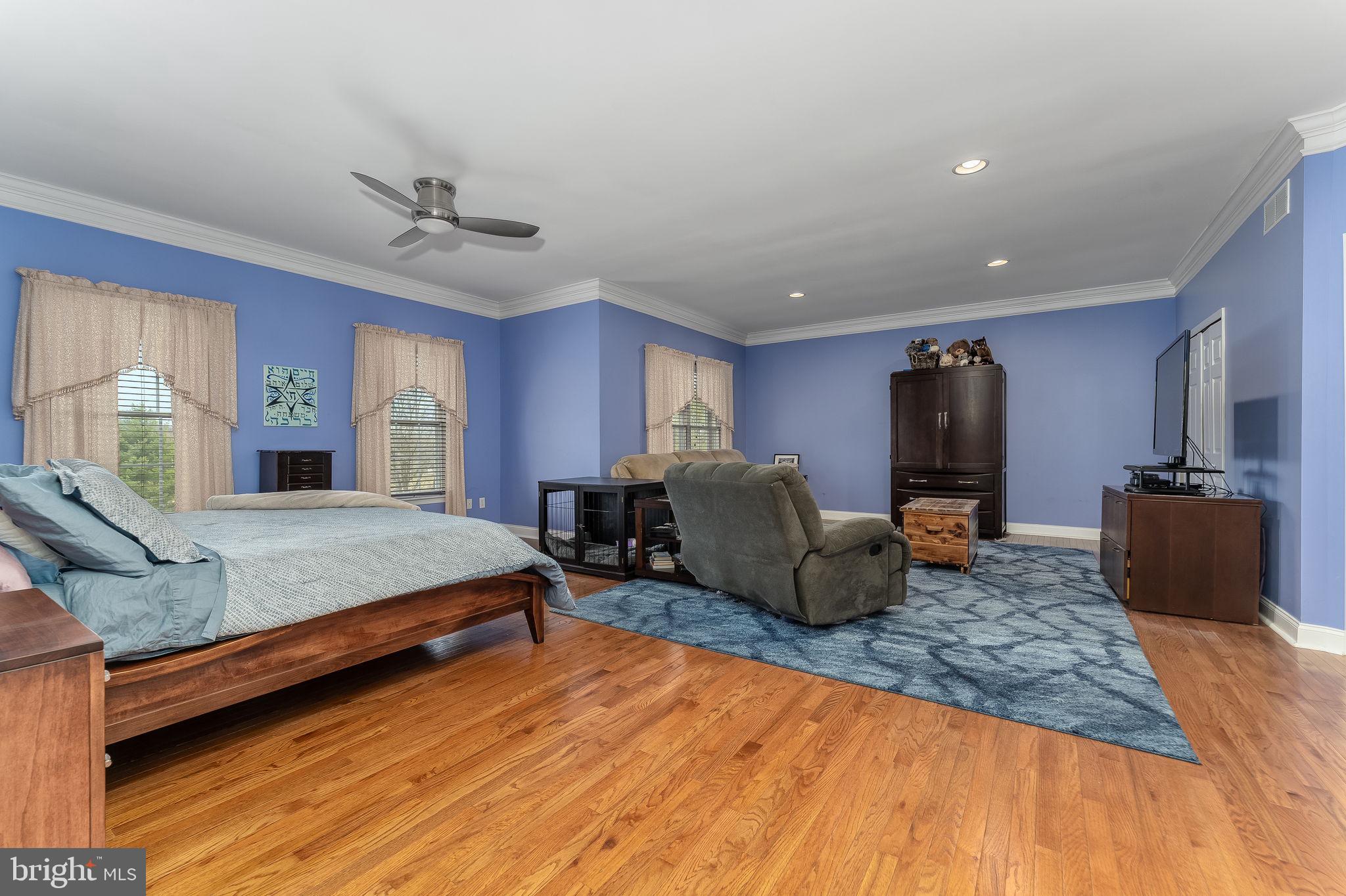 11 Baker Way Pennington, NJ 08534 - Photo 22 of 41 a spacious bedroom with a bed a couch and a flat screen television
