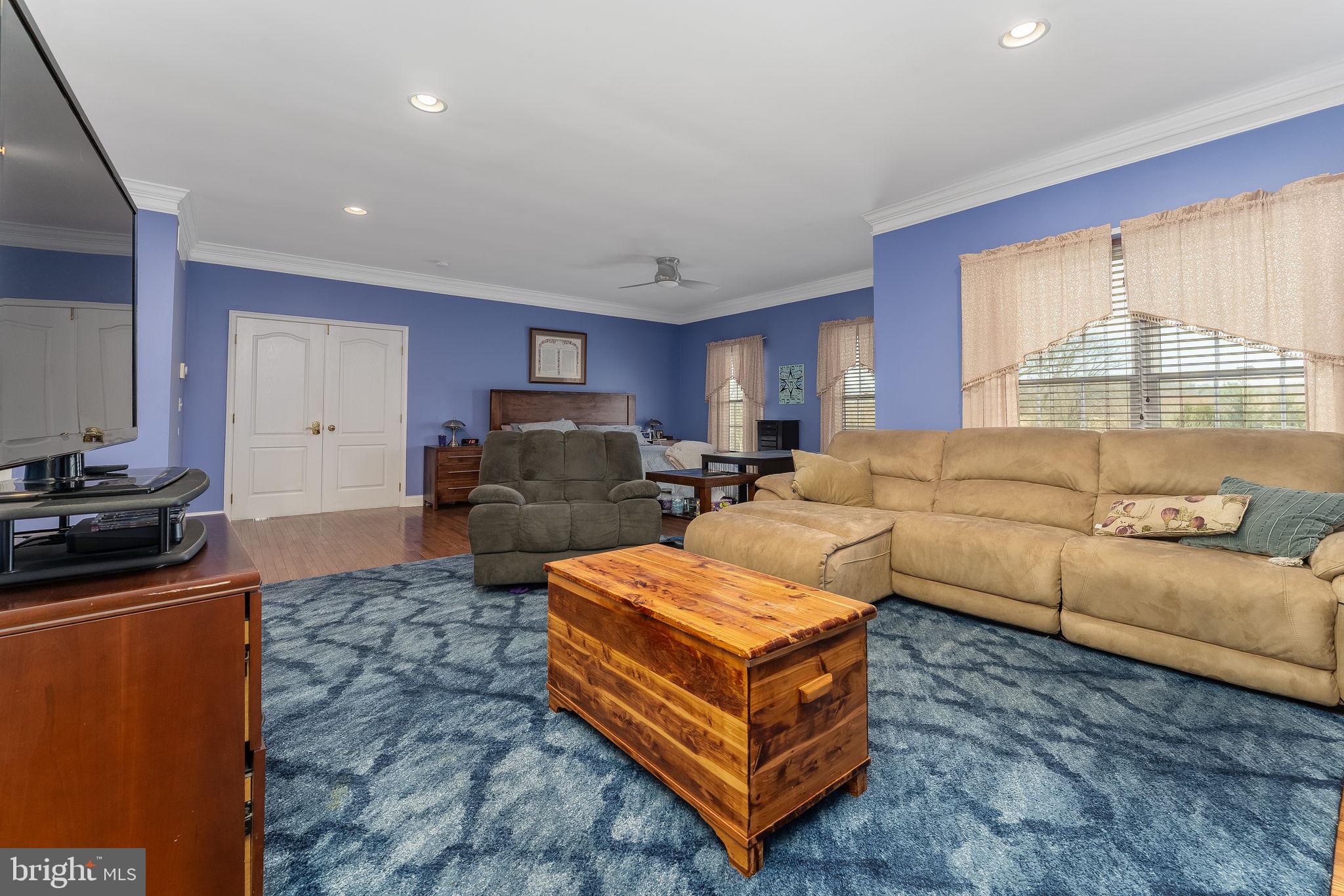 11 Baker Way Pennington, NJ 08534 - Photo 23 of 41 a living room with furniture a large window and a fireplace