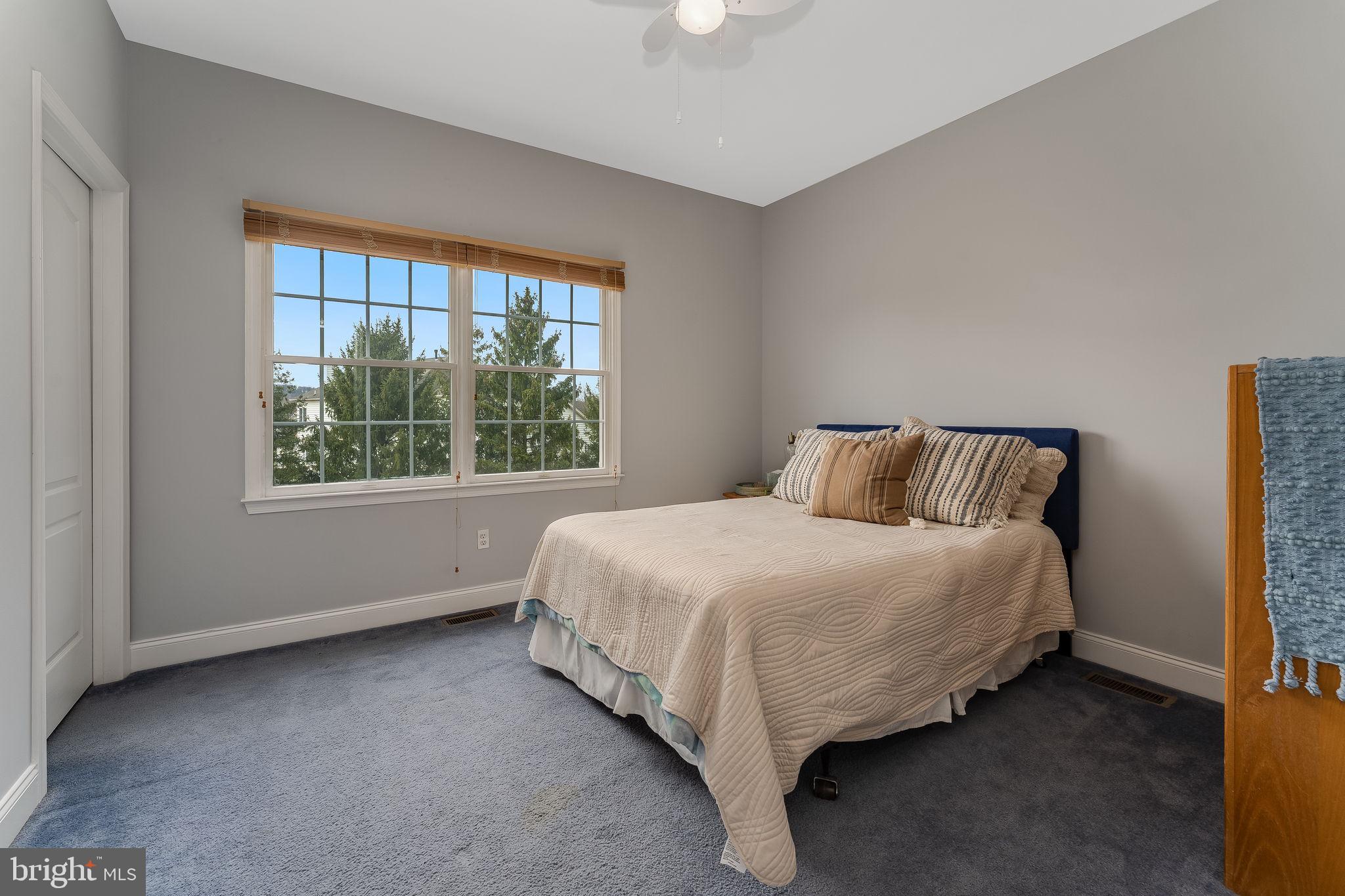 11 Baker Way Pennington, NJ 08534 - Photo 29 of 41 a bed sitting in a bedroom next to a window