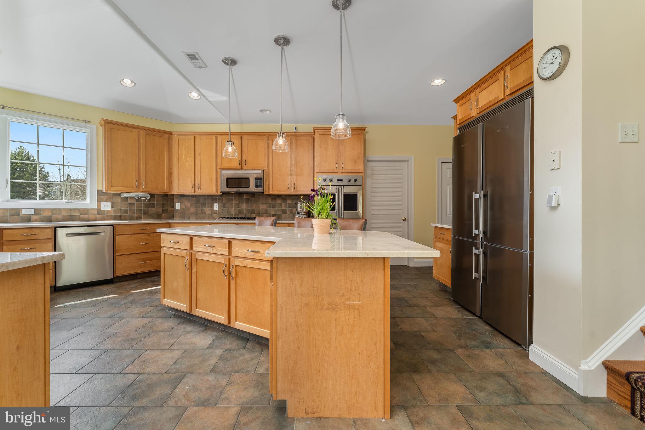 11 Baker Way Pennington, NJ 08534 - Photo 6 of 41 a kitchen with stainless steel appliances kitchen island granite countertop a stove refrigerator sink and cabinets