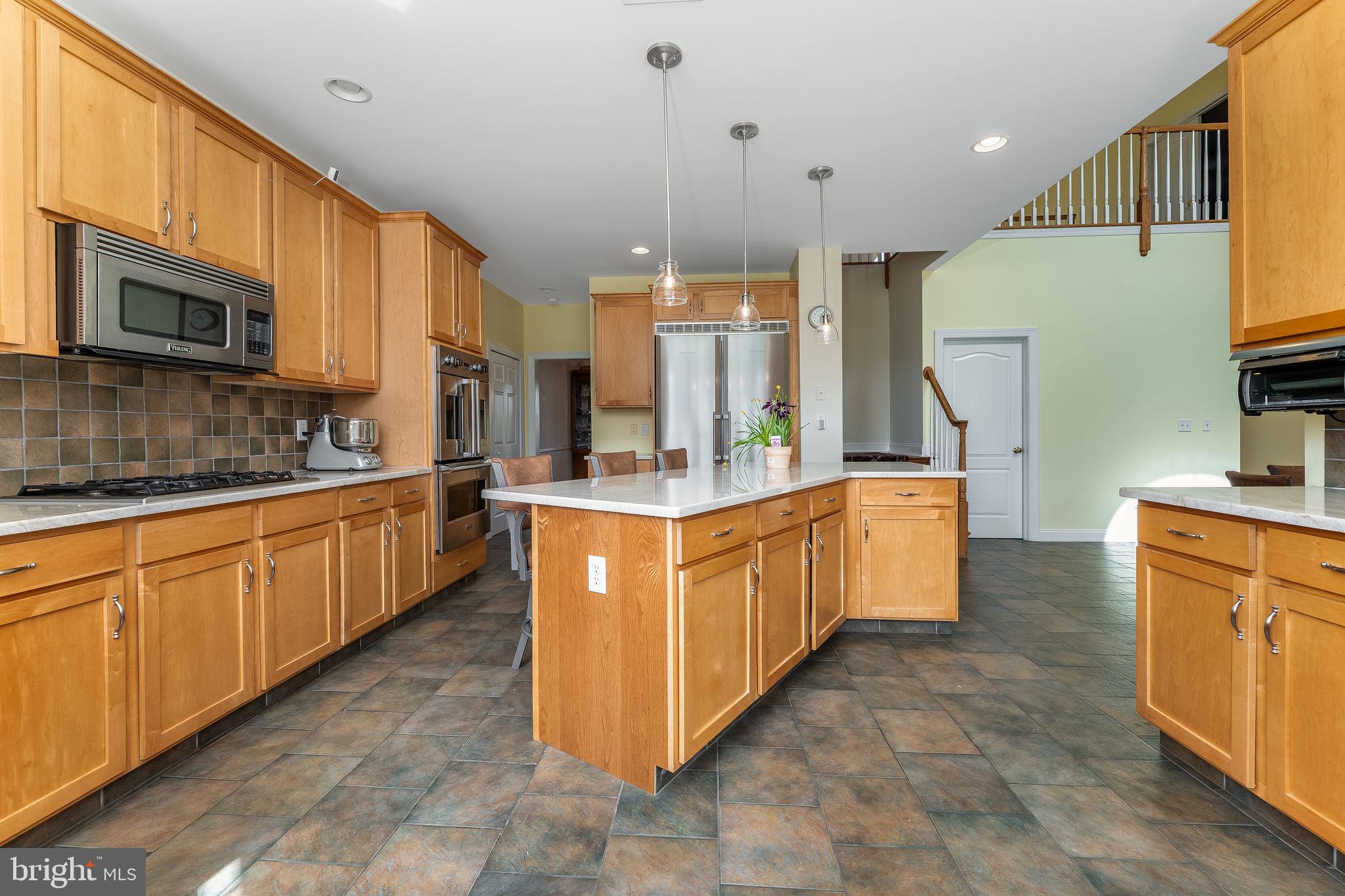11 Baker Way Pennington, NJ 08534 - Photo 8 of 41 a large kitchen with stainless steel appliances kitchen island granite countertop a stove a sink a refrigerator and a microwave