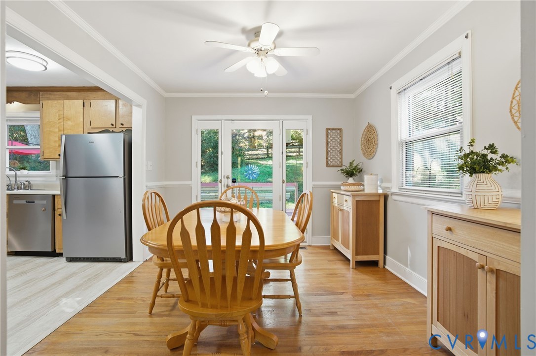 700 Brantley Road North Chesterfield, VA 23235 - Photo 16 of 40 a dining room with furniture a chandelier and wooden floor