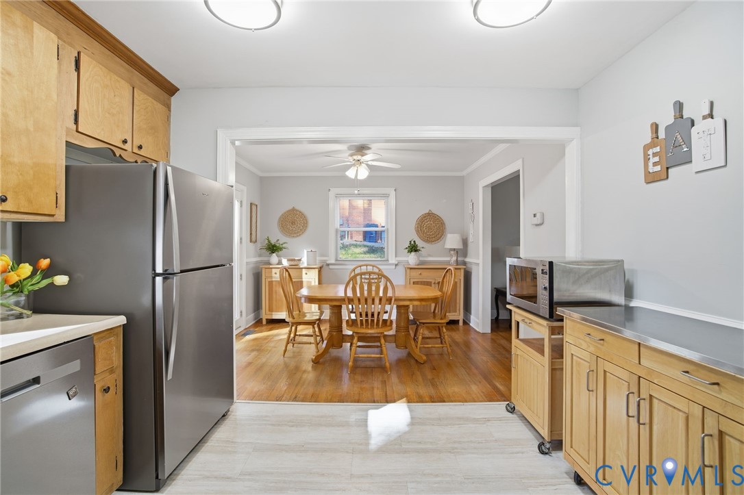 700 Brantley Road North Chesterfield, VA 23235 - Photo 20 of 40 a dining hall with stainless steel appliances granite countertop a refrigerator a stove and a dining table with wooden floor