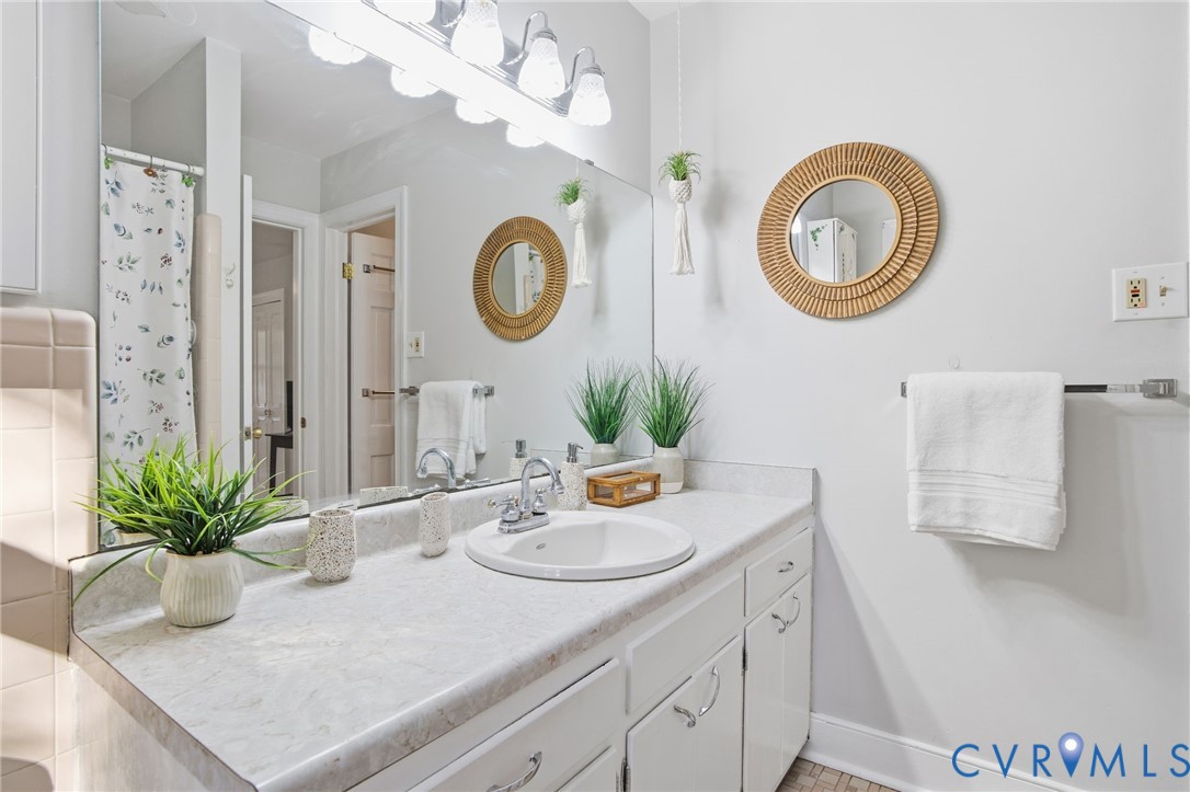 700 Brantley Road North Chesterfield, VA 23235 - Photo 34 of 40 a bathroom with a sink a mirror and a potted plant