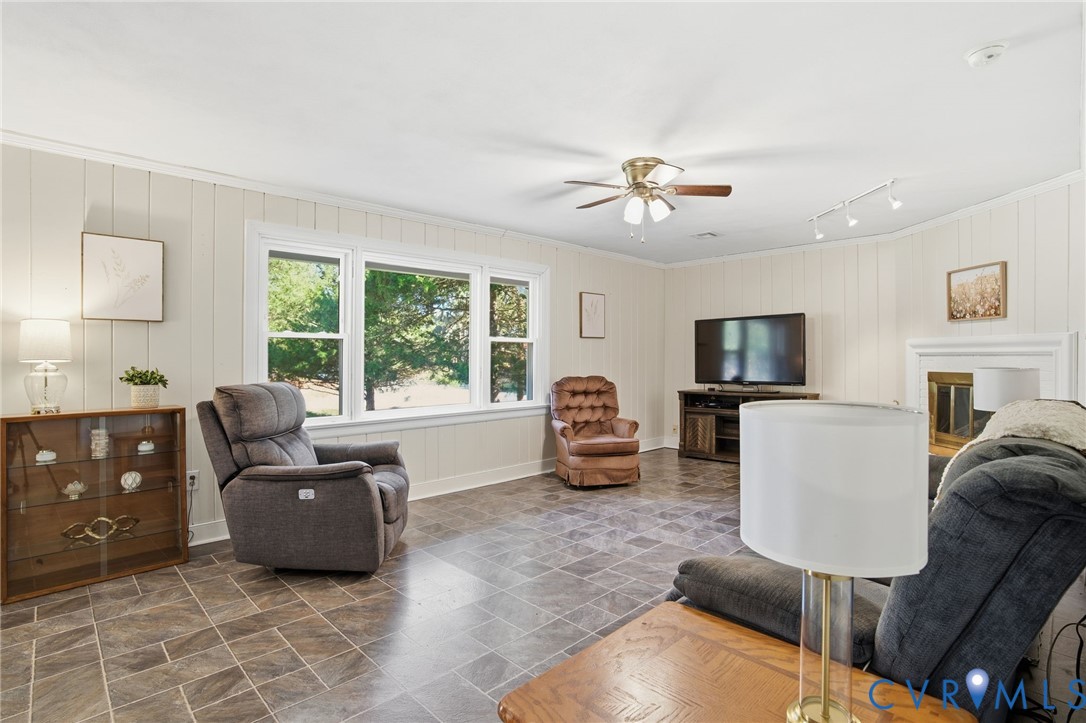 700 Brantley Road North Chesterfield, VA 23235 - Photo 8 of 40 a living room with furniture a flat screen tv and a large window