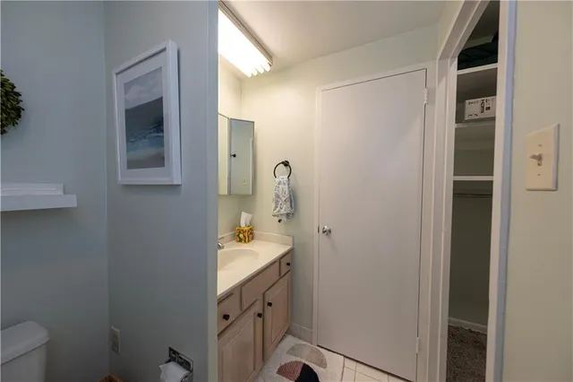 a bathroom with a sink a toilet and mirror