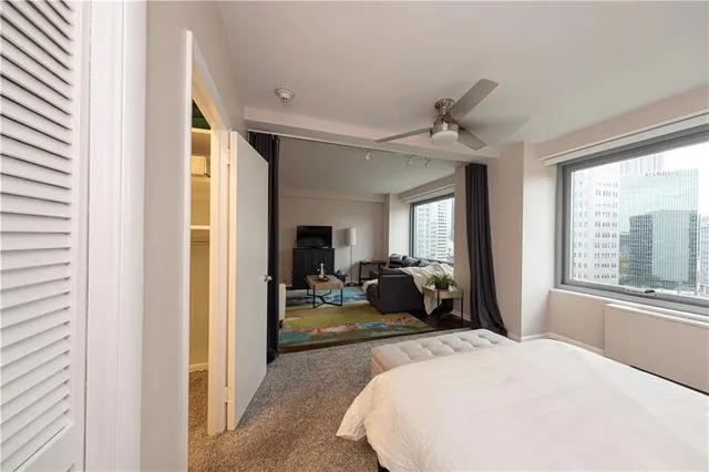 a bed room with a bed and a large window