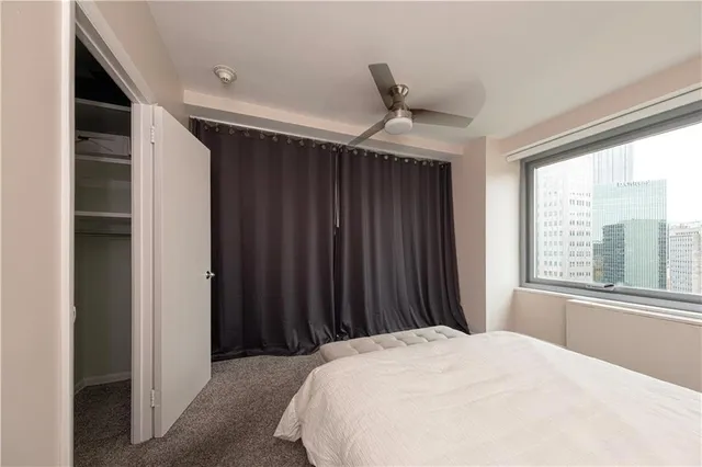 a bed room with a bed and a window