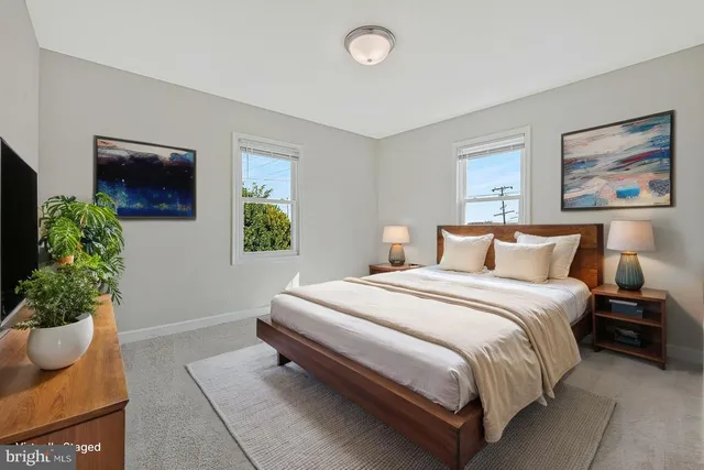 a bedroom with bed and a potted plant