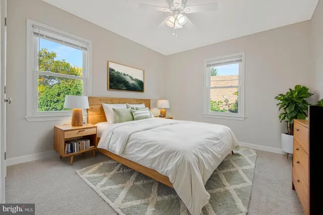 a bed sitting in a bedroom next to a window