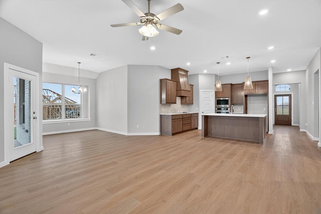 321 Skeen Peak Springtown, TX 76082 - Photo 12 of 37 Open-concept living space featuring wood-finish flooring, recessed lighting, and a ceiling fan