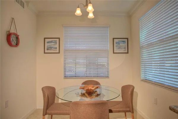 a dining room with furniture and window