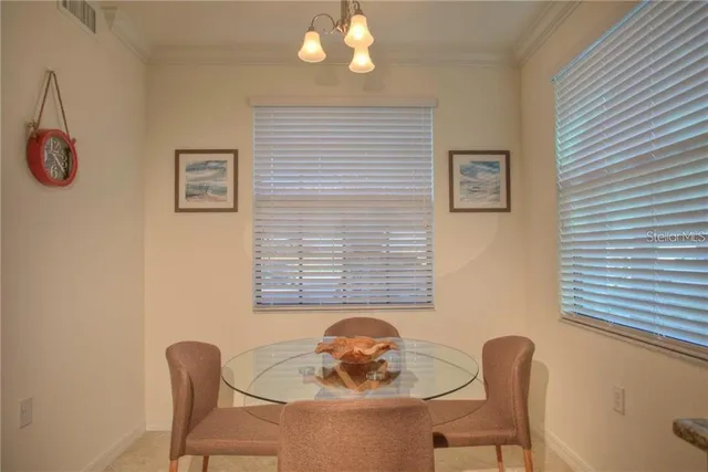 a dining room with furniture and window