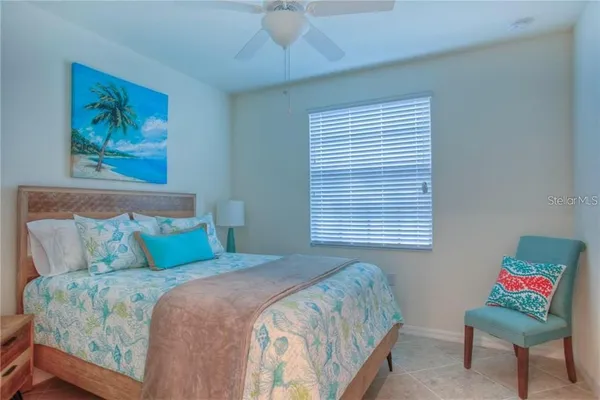 a bedroom with a bed and a painting on the wall