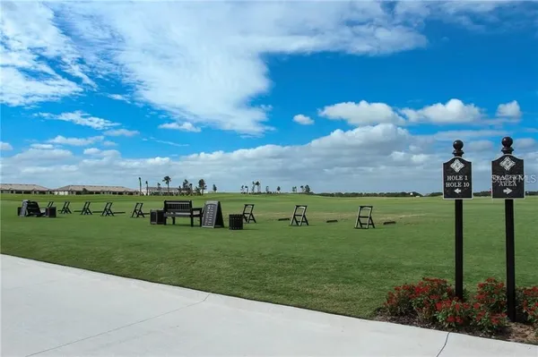a view of a golf course with a house