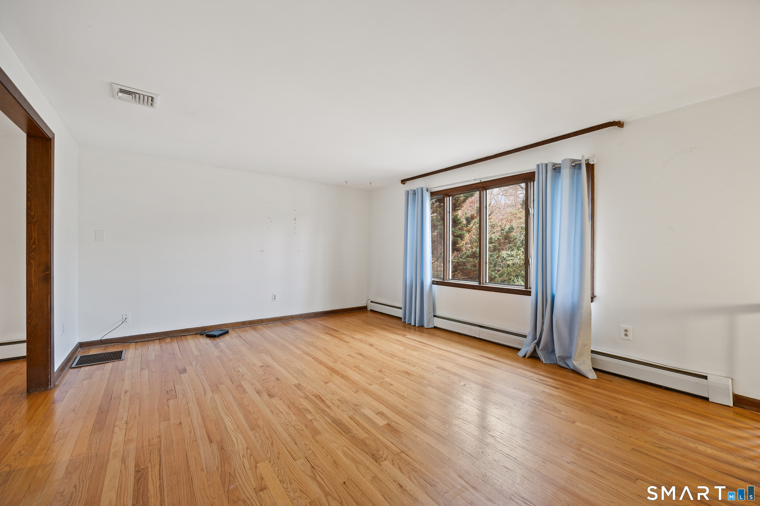 60 Roseanna Road Southington, CT 06479 - Photo 11 of 35 a view of an empty room with wooden floor and a window