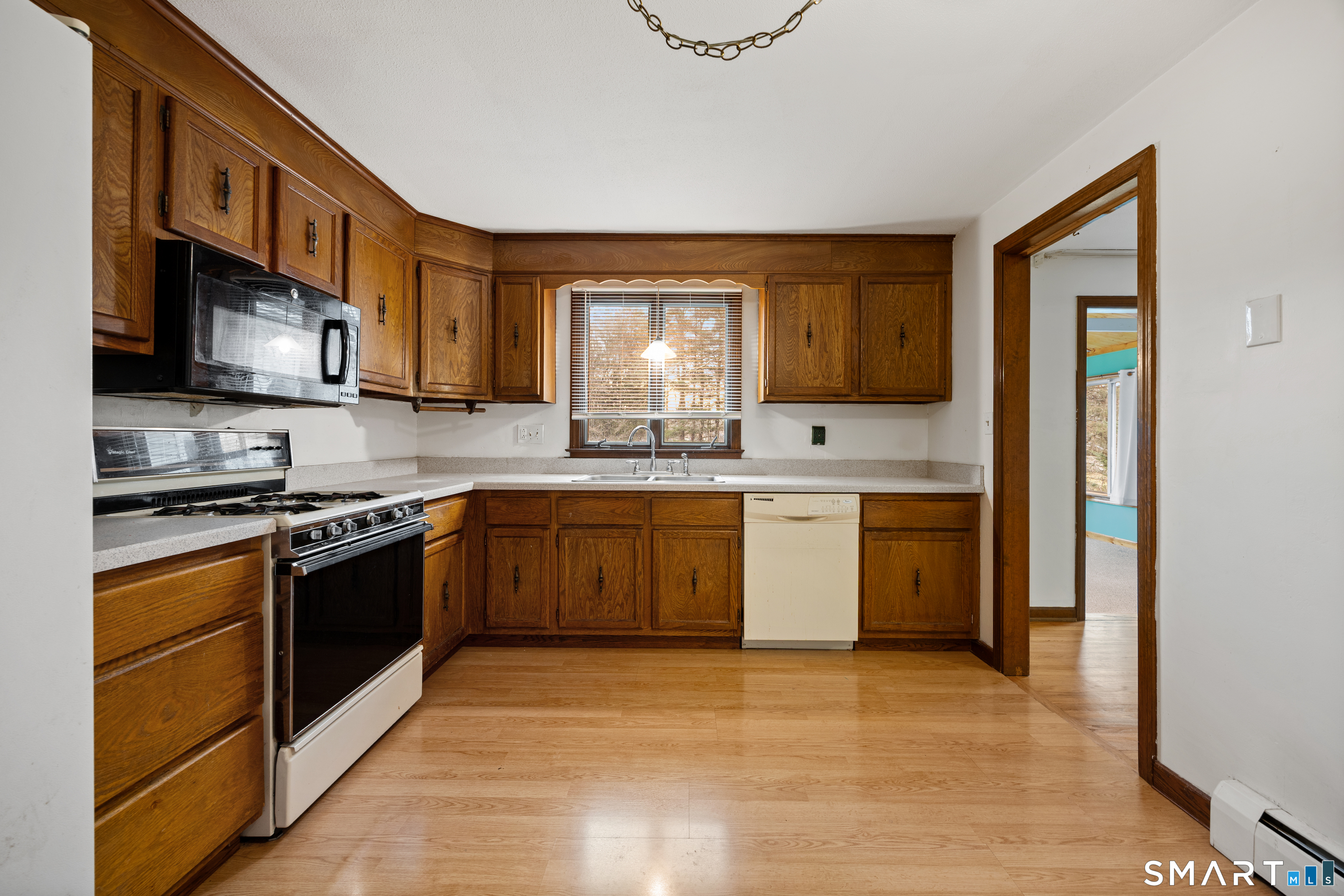 60 Roseanna Road Southington, CT 06479 - Photo 18 of 35 a kitchen with stainless steel appliances granite countertop a stove a sink and a microwave