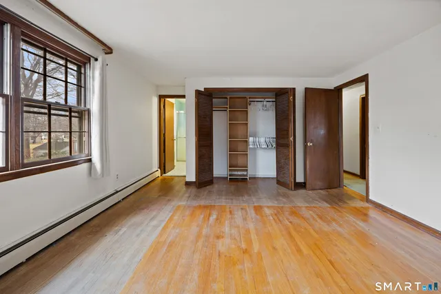 wooden floor in an empty room with a window