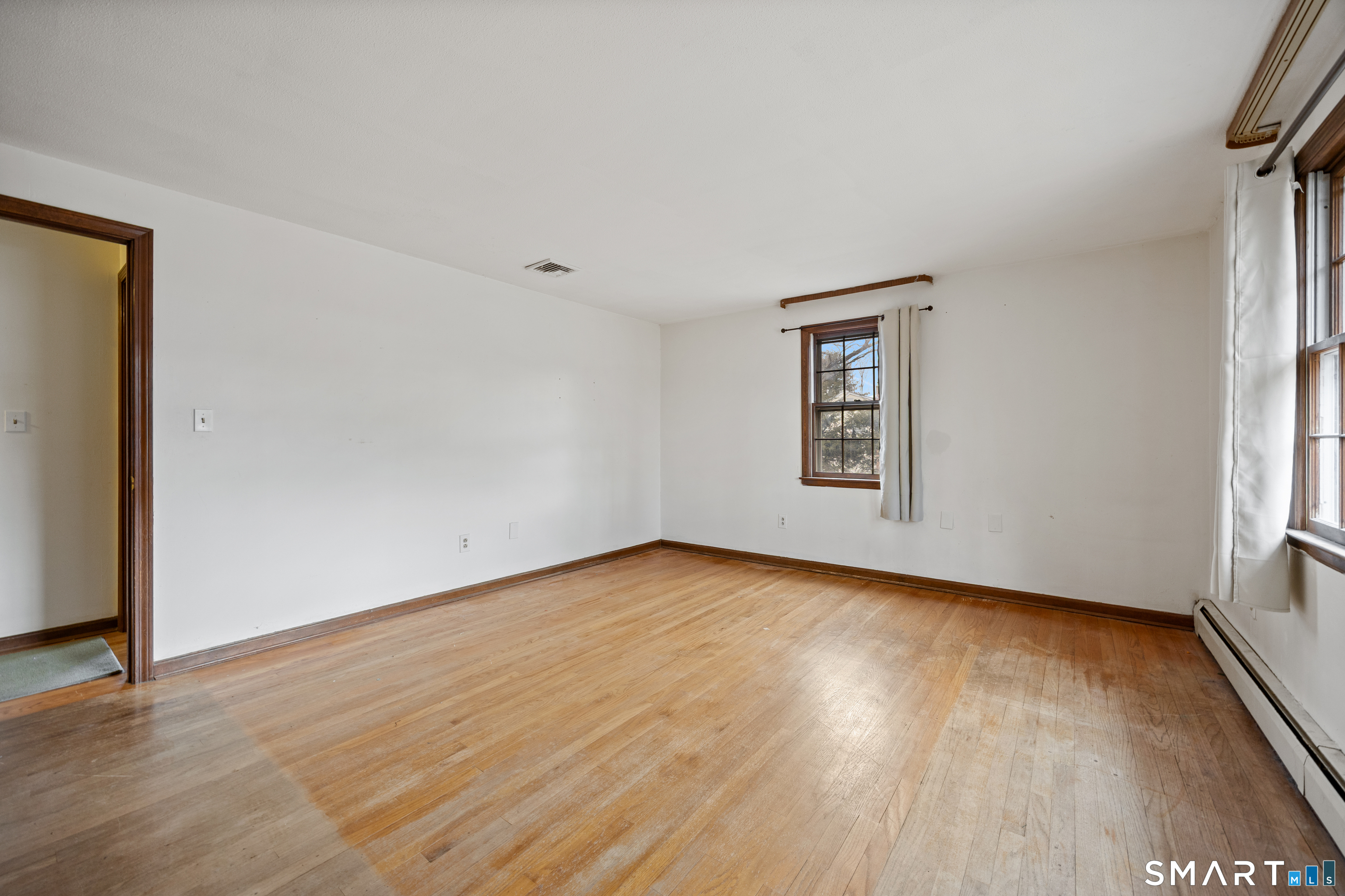 60 Roseanna Road Southington, CT 06479 - Photo 24 of 35 a view of an empty room with wooden floor and a window