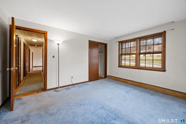 an empty room with windows and closet
