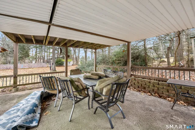 a view of a patio with a table chairs and a backyard