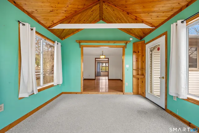 a view of a room that has wooden floor and a window