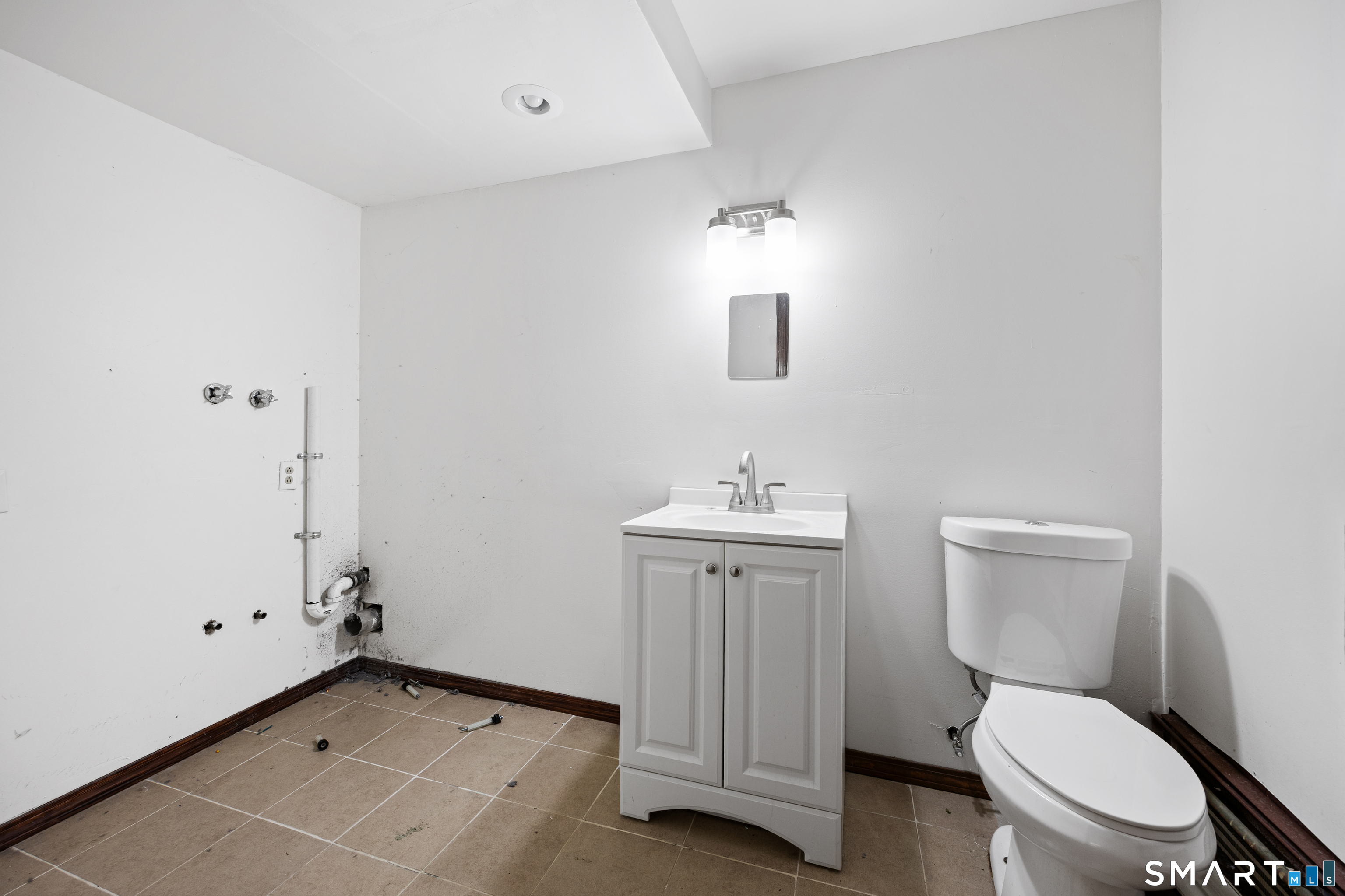 60 Roseanna Road Southington, CT 06479 - Photo 8 of 35 a bathroom with a toilet a sink and mirror