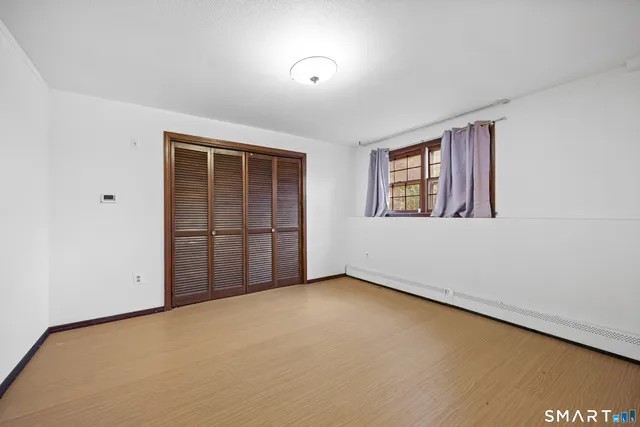 an empty room with a empty space and windows