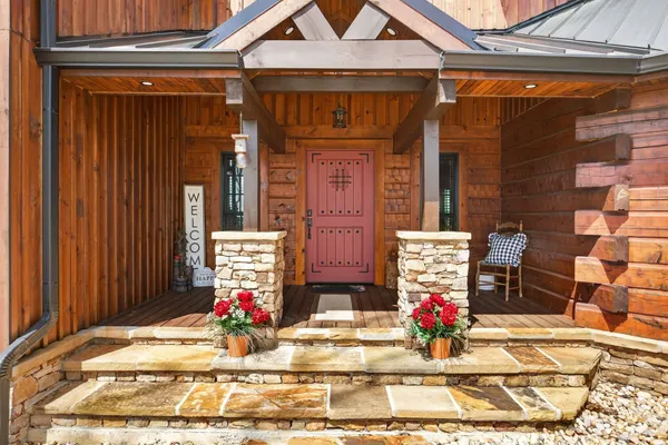 a outdoor living space with furniture a flat screen tv and a fireplace