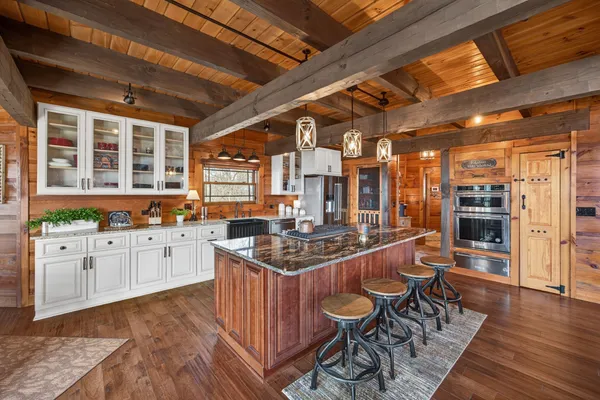 a kitchen with stainless steel appliances granite countertop a stove and a refrigerator