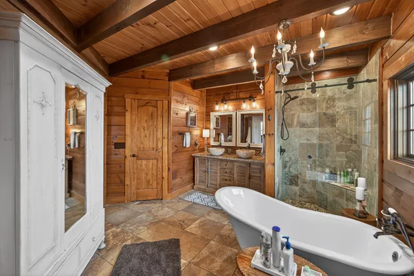 a bathroom with a sink a mirror and a shower