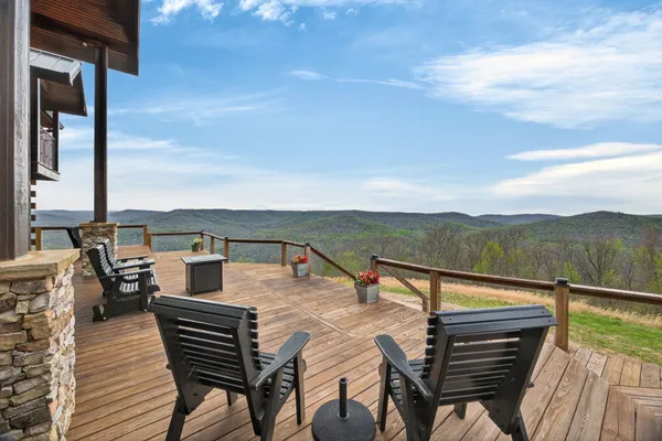 a view of a roof deck with couches and wooden floor