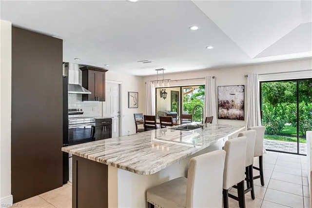 a kitchen with granite countertop center island and stainless steel appliances