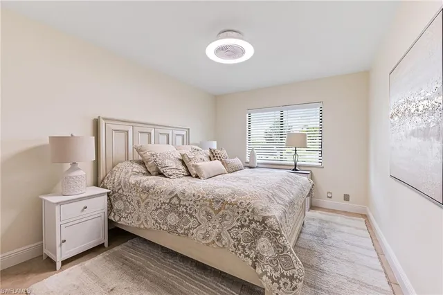 a bed room with a bed and a window