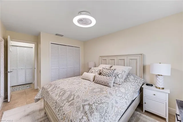 a bedroom with a bed and a lamp