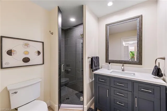a bathroom with a double vanity sink toilet and shower