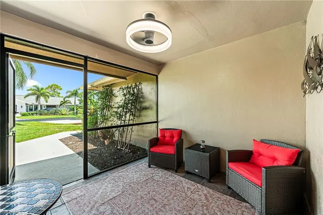 a living room with a rug and a floor to ceiling window