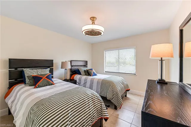 a bedroom with two beds and a window