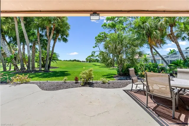 a view of a patio with a table and chairs